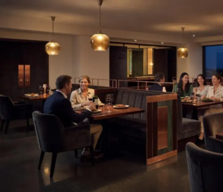 Moody Australian supper club dining room with copper accents, candlelit tables and timber finishes